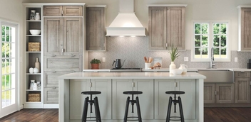 Waypoint kitchen image with island and stools. Cabinets are a rustic brown, while the island is white