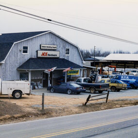 Photo taken of the Talbert Lumber & Hardware store in the late 80's with several cars in the front parking lot.