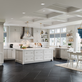 White kitchen cabinets and island with a blue chandelier over dining table