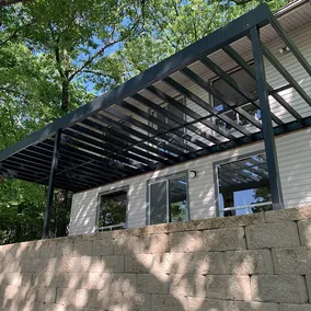 A photo showing an elevated deck built with evolution steel decking framing from fortress building products, showing an extremely durable alternative to outdoor living decking framing and construction