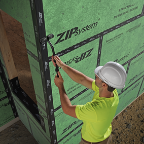 Photo of construction worker assembling Zip System on a project.