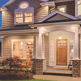 Pictured is the front of a home featuring a Rogue Valley door from Tucker Door and Trim.