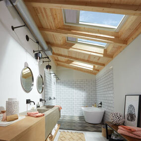 Pictured is a modern bathroom with Velux skylights